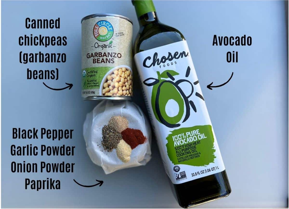 Ingredients for crispy chickpeas. Includes a can of chickpeas (garbanzo beans), avocado oil, and seasonings (black pepper, garlic powder, onion powder, and paprika.