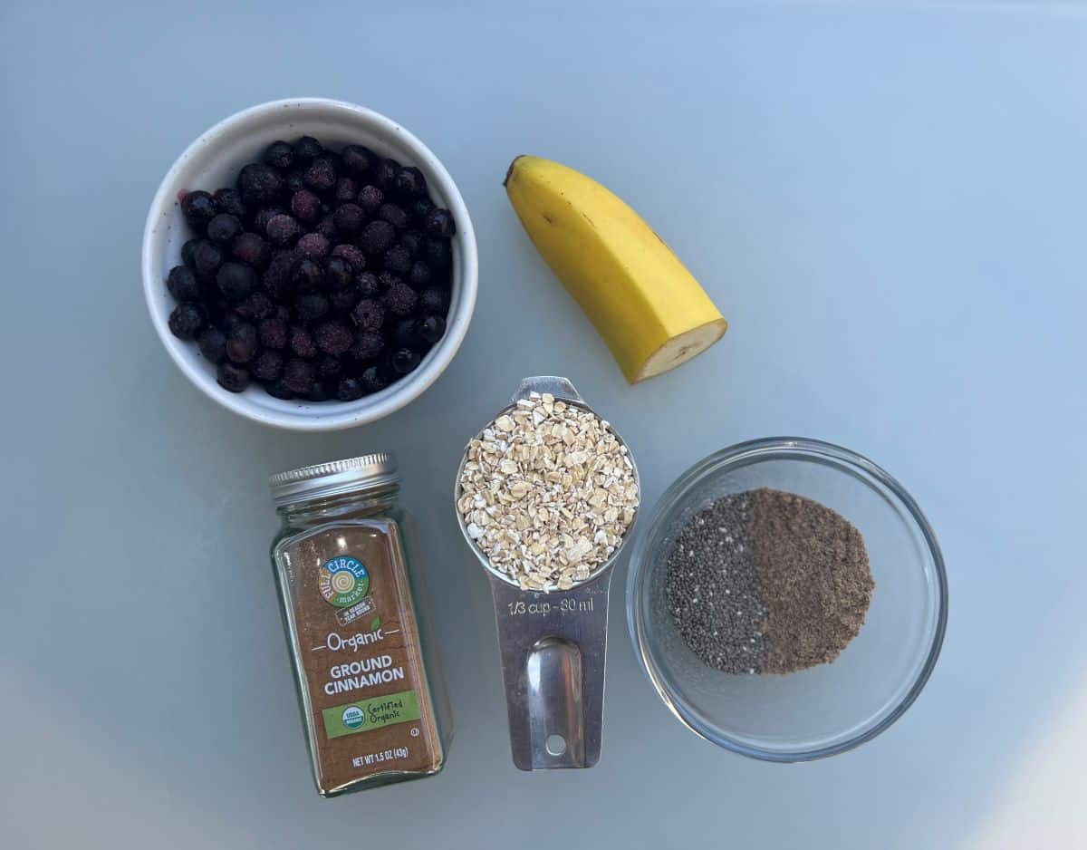 Oatmeal ingredients: blueberries, banana, dry oats, cinnamon, ground flaxseed and chia seeds