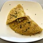 Eggless veggie omelette made out of chickpea flour with sauteed veggies inside.
