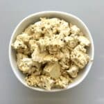 Bowl of plant based feta cheese made out of tofu and marinade.