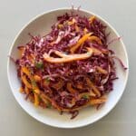 Purple cabbage slaw made out of cabbage, bell pepper, cilantro and a tangy dressing.