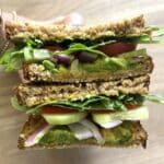 Kidney friendly veggie sandwich sliced in half showing the veggies inside.