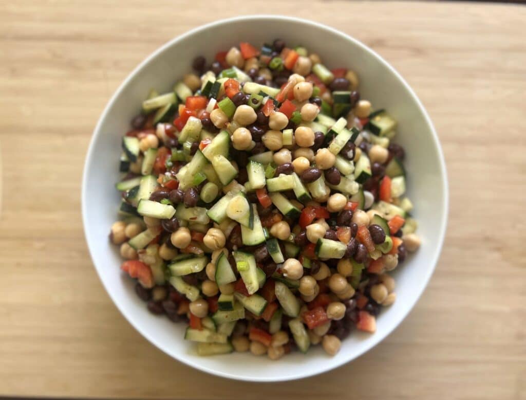 Black bean chickpea salad with veggies and dressing.