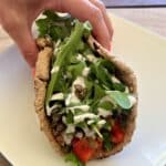 Pita Wrap Recipe with lentils, veggies, and yogurt dressing folded inside.