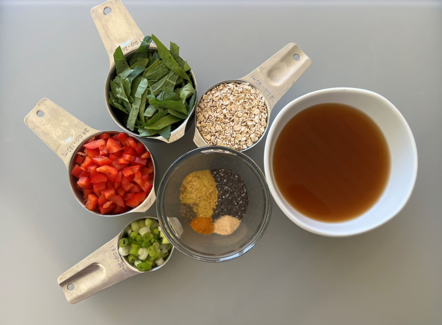 Savory vegetable oats ingredients. Contains veggies, low sodium veggie broth, seasoning and dry oats.