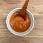 Low sodium roasted veggie pasta sauce in a bowl with a spoon.