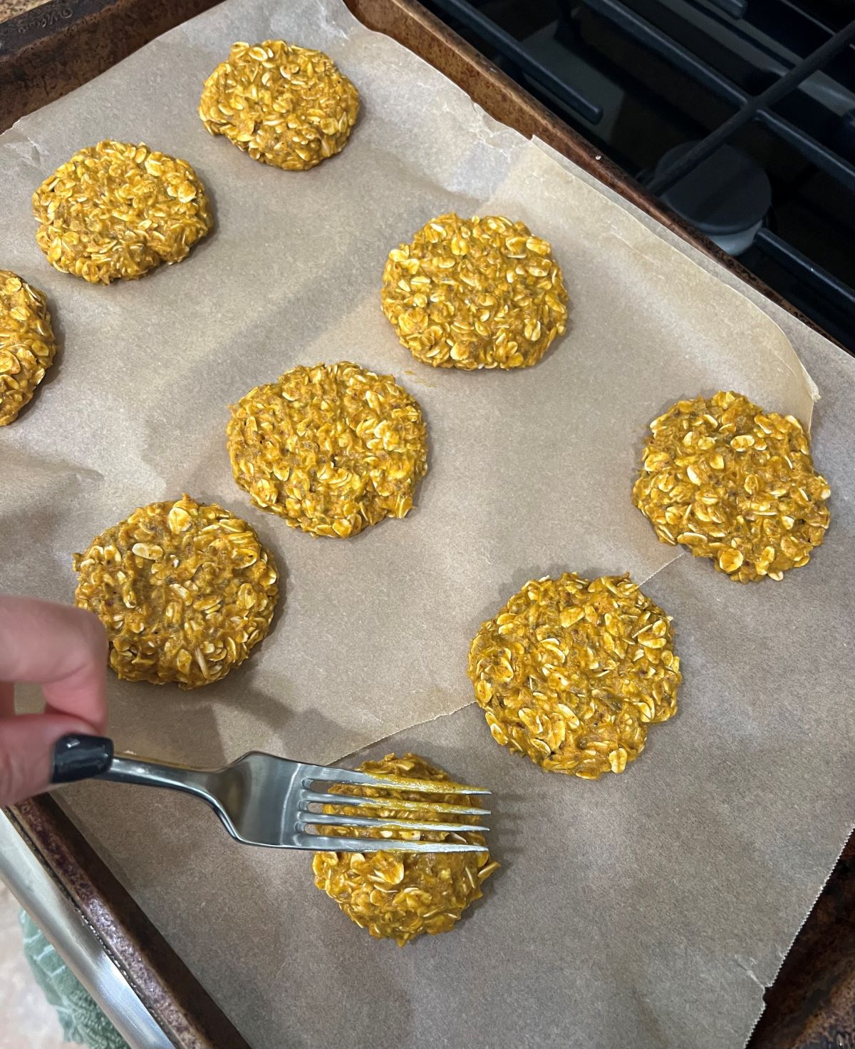 Peanut butter pumpkin cookies laid out on cooking sheet ready to go in the oven.