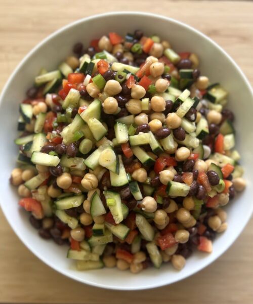 Black bean chickpea salad with veggies and dressing.